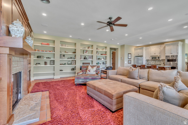 2579 Splendor Valley Road Kamas, UT 84036 - Photo 59 of 87 Living room with a ceiling fan, recessed lighting, a glass covered fireplace, and built in shelves