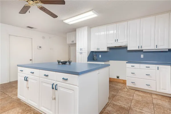 a kitchen with cabinets appliances and a counter space