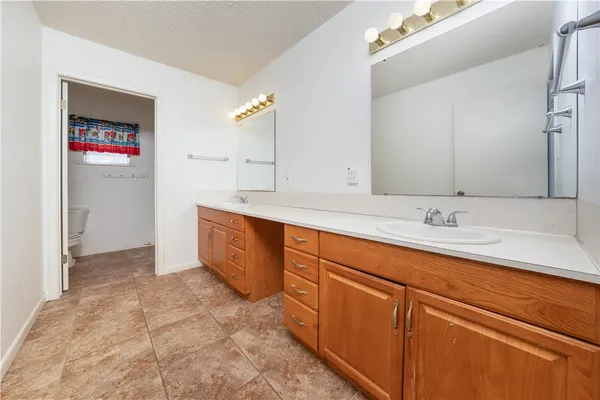 a spacious bathroom with a sink and a mirror