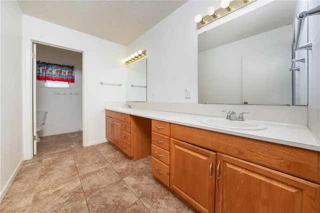 a spacious bathroom with a sink and a mirror