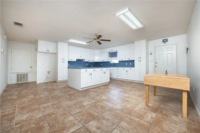 a large kitchen with cabinets and a stove