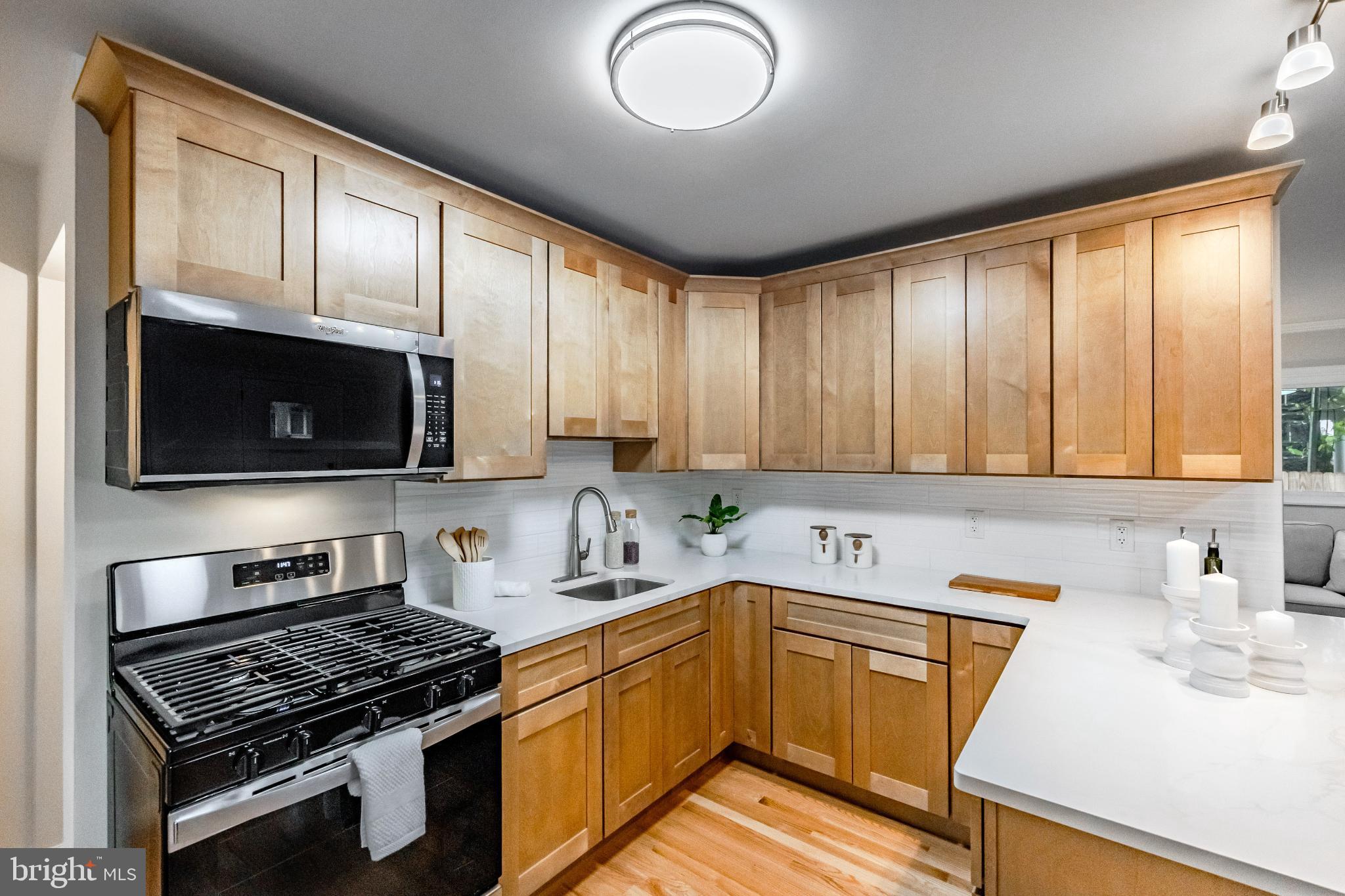 241 South Cedar Lane Upper Darby, PA 19082 - Photo 11 of 29 Modern kitchen with warm wood cabinetry.