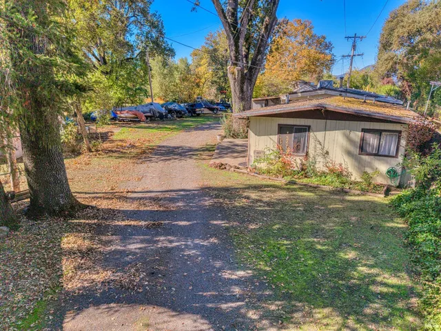 a view of a yard with yellow house