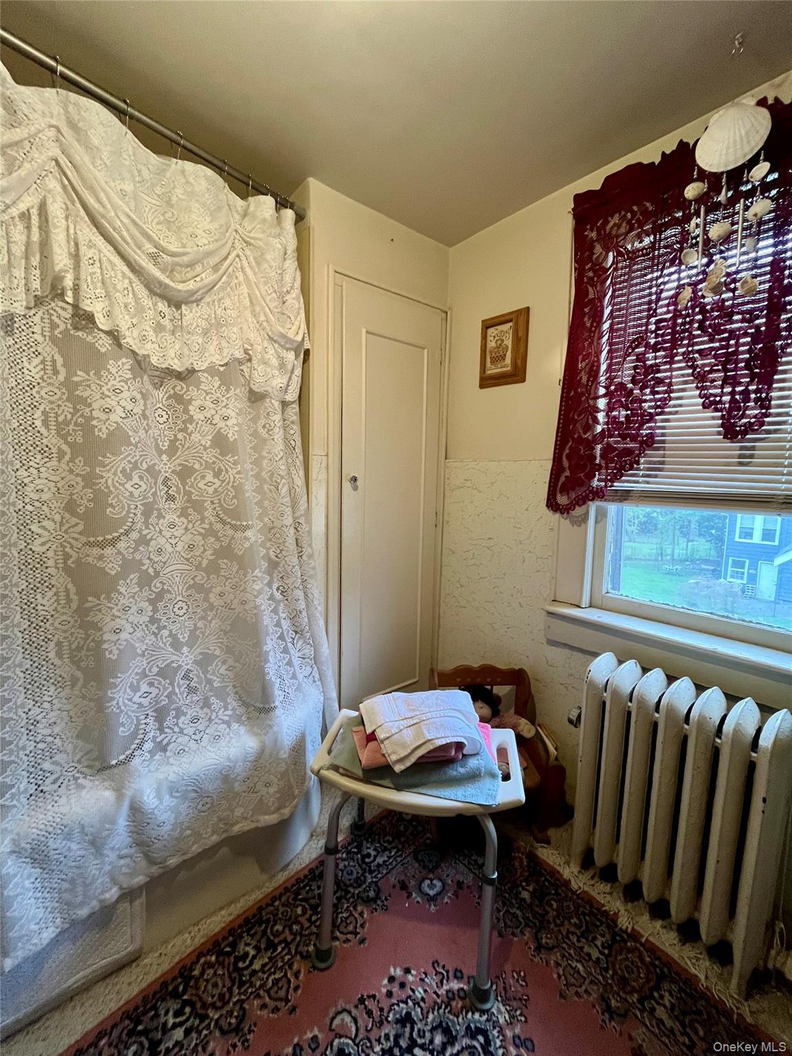 35 Spring Street Goshen, NY 10924 - Photo 22 of 26 a bathroom with a sink and a mirror