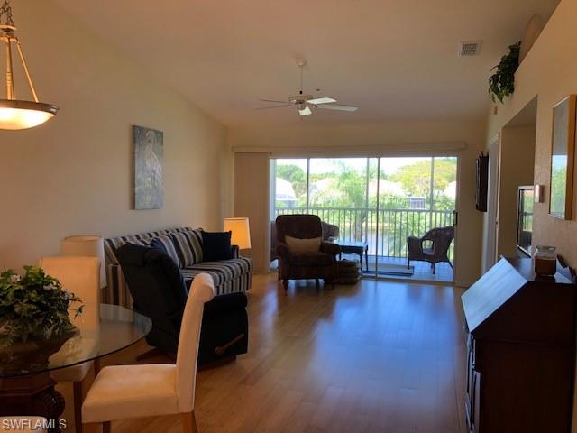 9009 Michael Circle, Unit 1110 Naples, FL 34113 - Photo 11 of 27 a living room with furniture and a large window