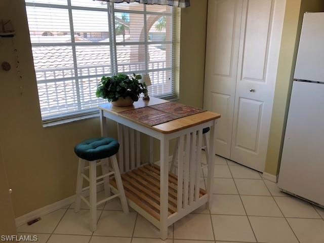 9009 Michael Circle, Unit 1110 Naples, FL 34113 - Photo 12 of 27 a kitchen with a sink and a stove