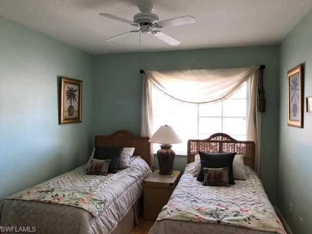 9009 Michael Circle, Unit 1110 Naples, FL 34113 - Photo 13 of 27 a bedroom with bed and window