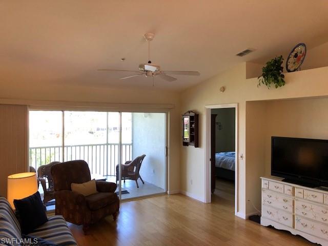 9009 Michael Circle, Unit 1110 Naples, FL 34113 - Photo 14 of 27 a view of a livingroom with furniture and a flat screen tv