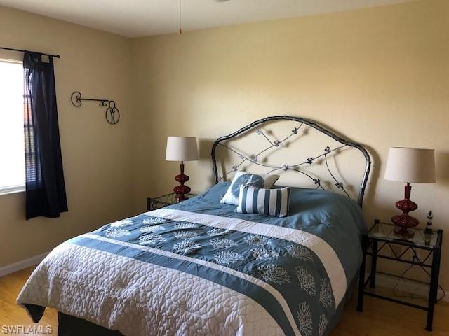 9009 Michael Circle, Unit 1110 Naples, FL 34113 - Photo 16 of 27 a bedroom with a bed and a mirror