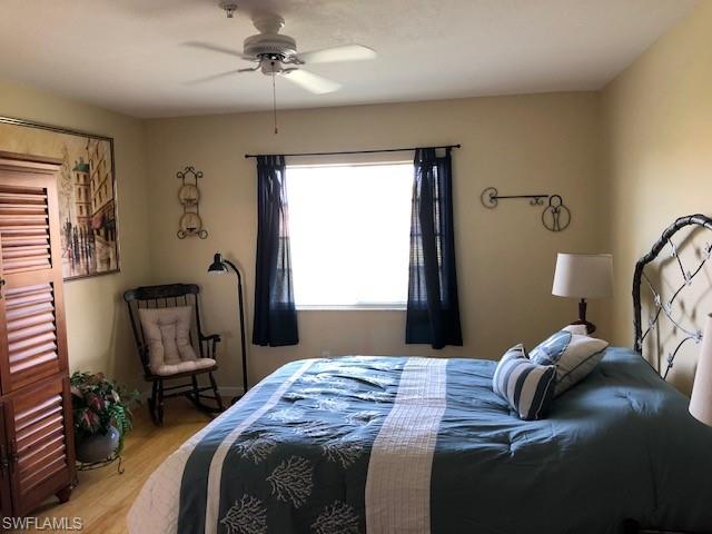 9009 Michael Circle, Unit 1110 Naples, FL 34113 - Photo 17 of 27 a bedroom that has a bed window and chair