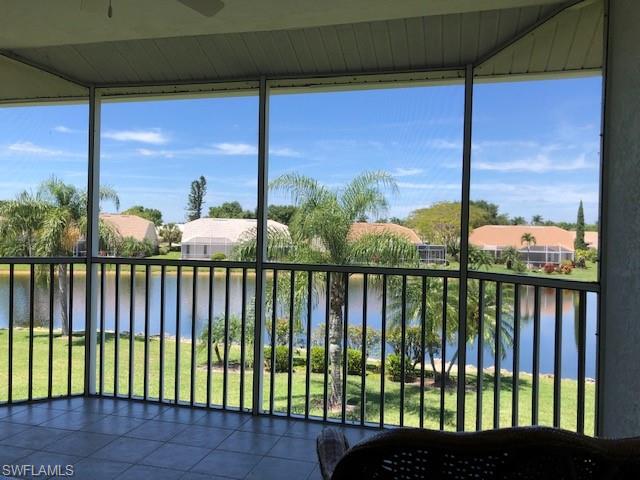 9009 Michael Circle, Unit 1110 Naples, FL 34113 - Photo 2 of 27 a view of a balcony with floor to ceiling windows with wooden floor