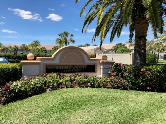 9009 Michael Circle, Unit 1110 Naples, FL 34113 - Photo 24 of 27 a front view of a house with a yard