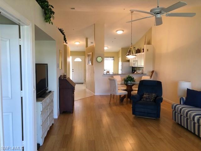 9009 Michael Circle, Unit 1110 Naples, FL 34113 - Photo 4 of 27 a living room with furniture and a flat screen tv