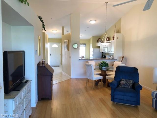 9009 Michael Circle, Unit 1110 Naples, FL 34113 - Photo 5 of 27 a living room with furniture and a flat screen tv