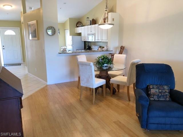 9009 Michael Circle, Unit 1110 Naples, FL 34113 - Photo 6 of 27 a living room with furniture and a table