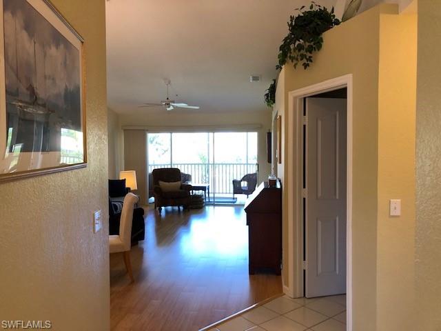 9009 Michael Circle, Unit 1110 Naples, FL 34113 - Photo 10 of 27 a living room with furniture and a large window