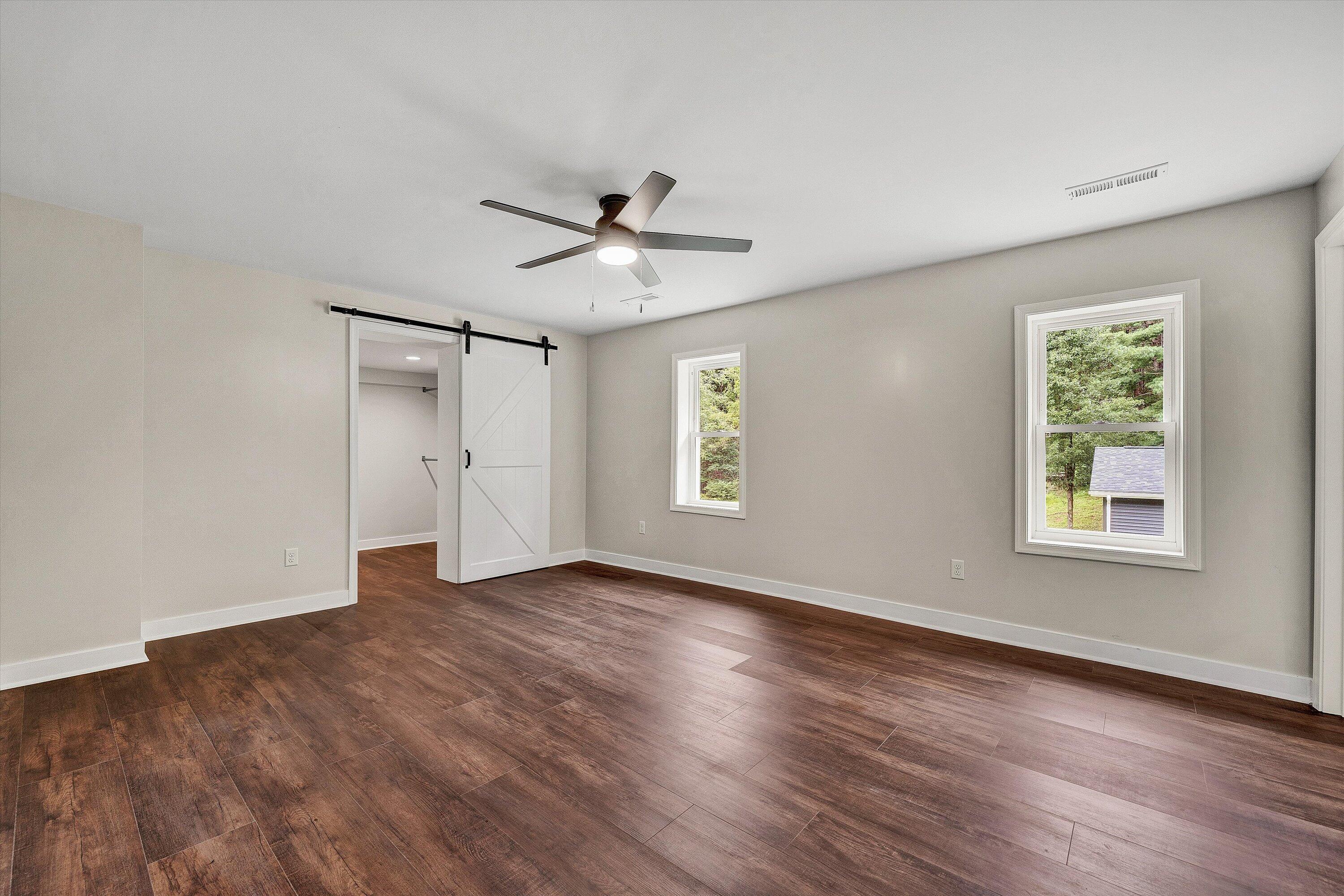 251 Meadow Branch Road Boones Mill, VA 24065 - Photo 11 of 34 a view of an empty room with a window and wooden floor