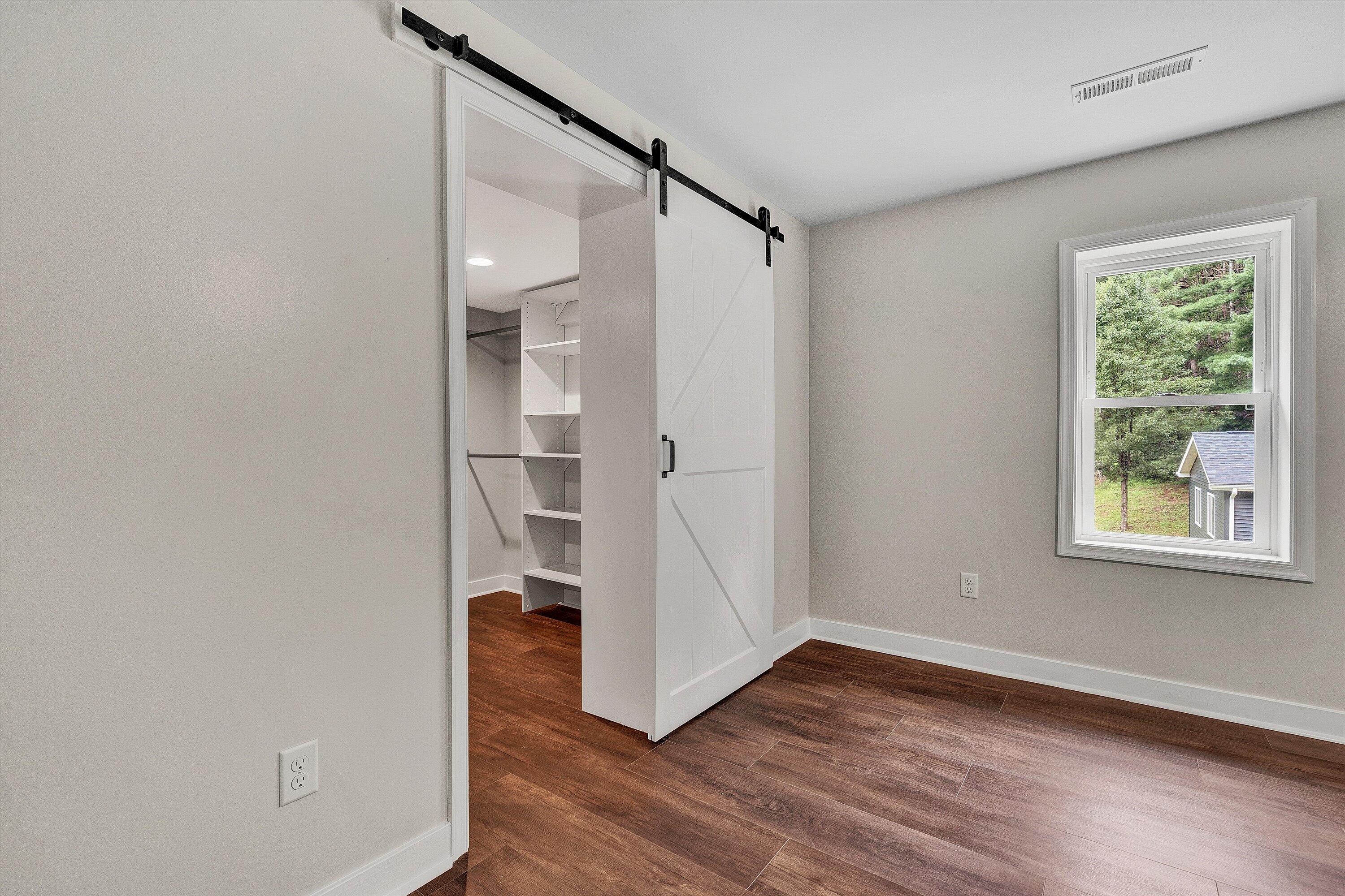251 Meadow Branch Road Boones Mill, VA 24065 - Photo 13 of 34 a view of empty room with wooden floor and fan