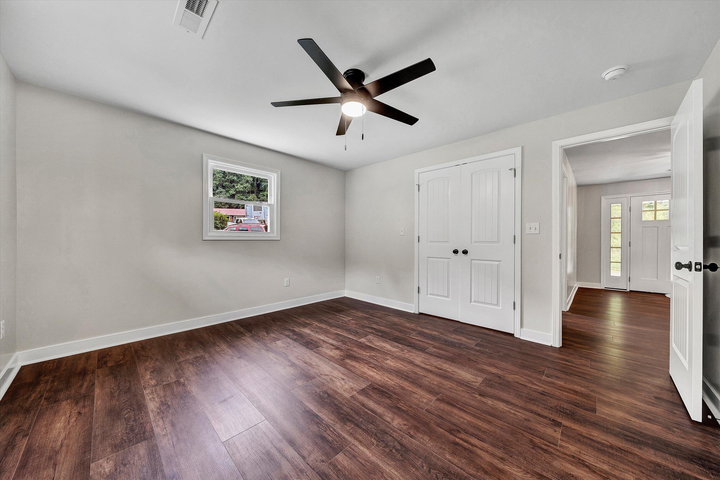 251 Meadow Branch Road Boones Mill, VA 24065 - Photo 20 of 34 a view of empty room with wooden floor and ceiling fan