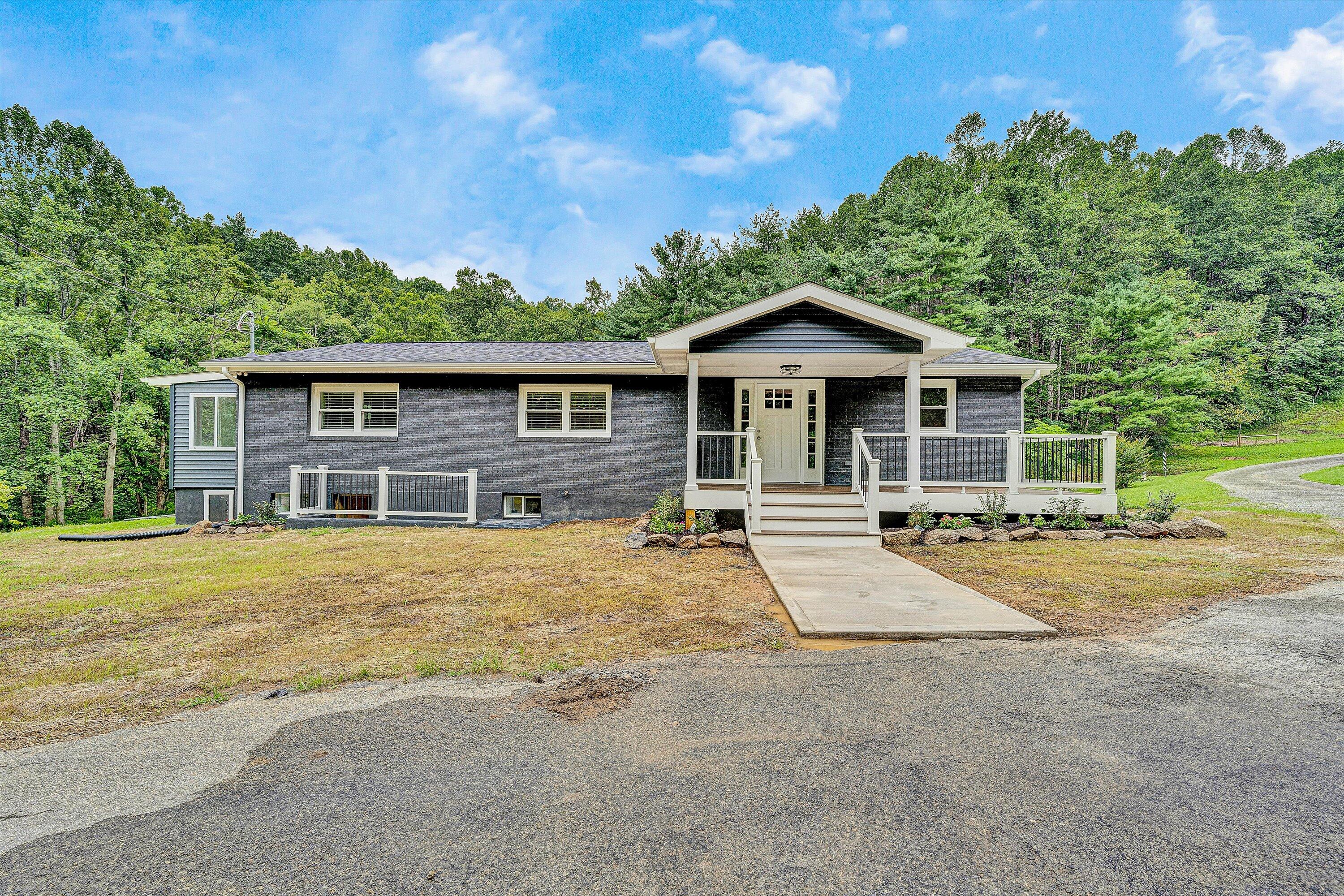 251 Meadow Branch Road Boones Mill, VA 24065 - Photo 2 of 34 a front view of a house with a garden
