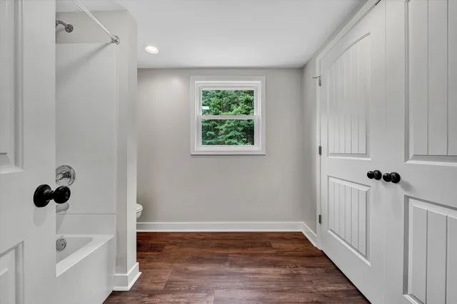 a view of a bathroom with a tub and sink
