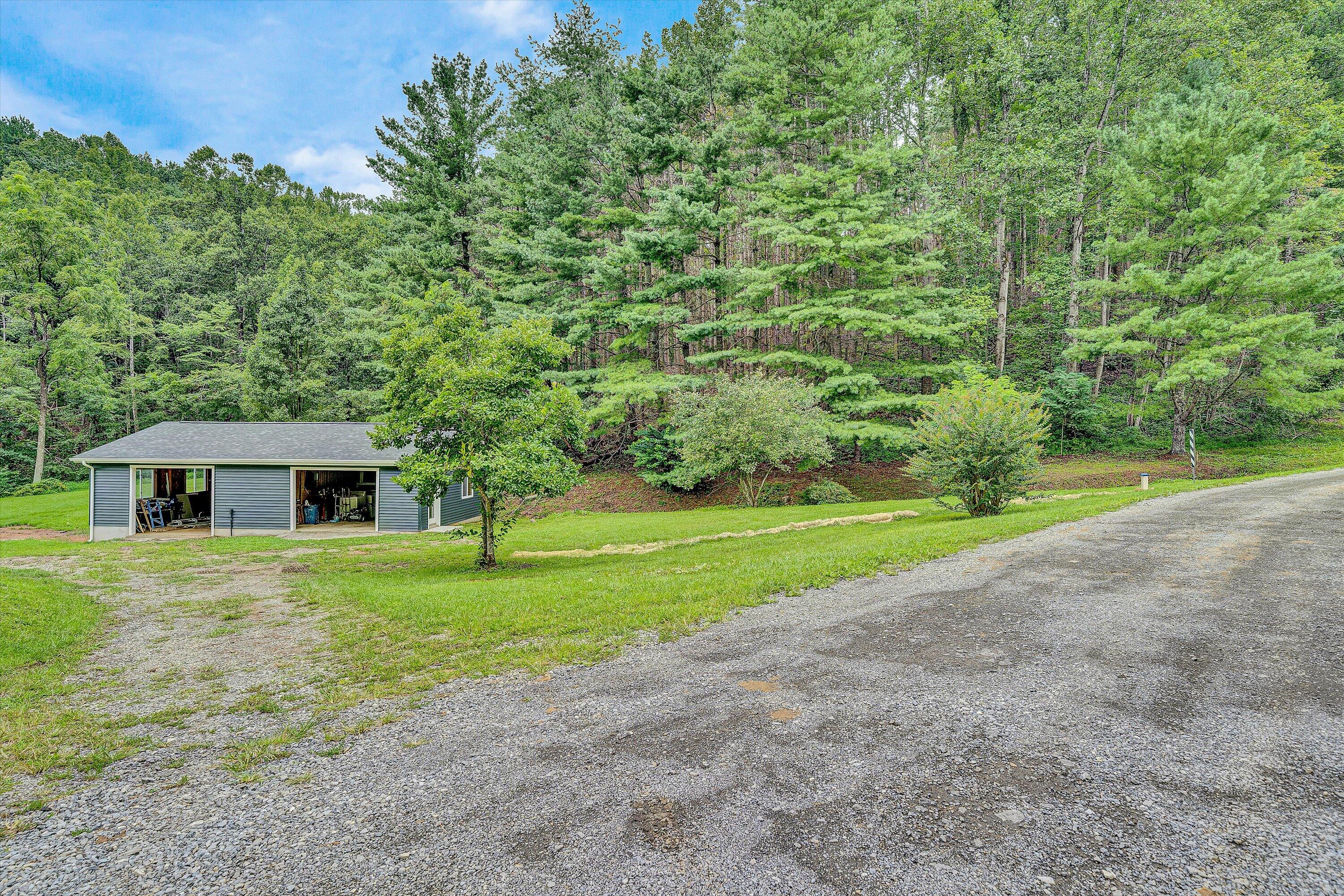 251 Meadow Branch Road Boones Mill, VA 24065 - Photo 28 of 34 a house with trees in the background