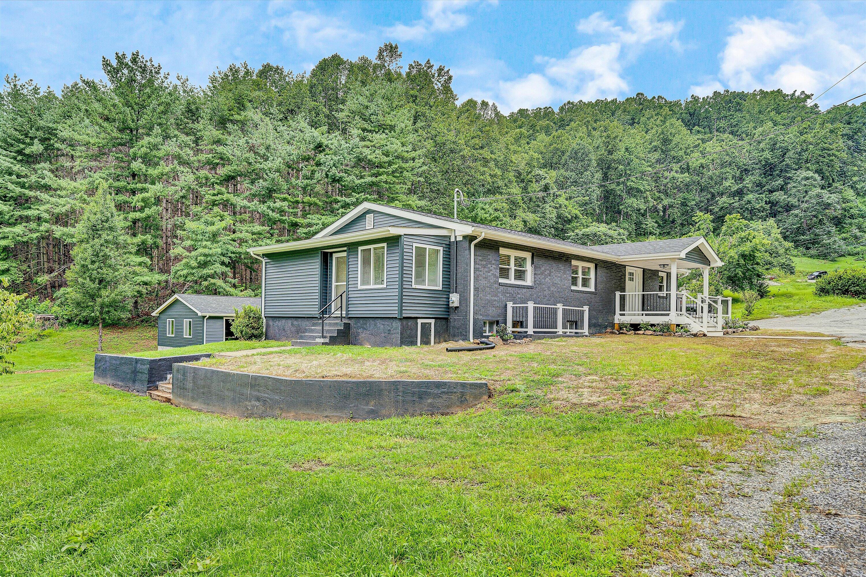 251 Meadow Branch Road Boones Mill, VA 24065 - Photo 34 of 34 a front view of a house with a yard table and chairs