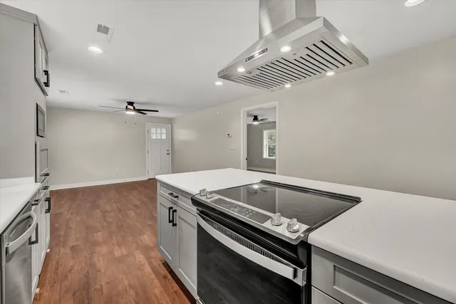 a kitchen with a sink appliances and cabinets