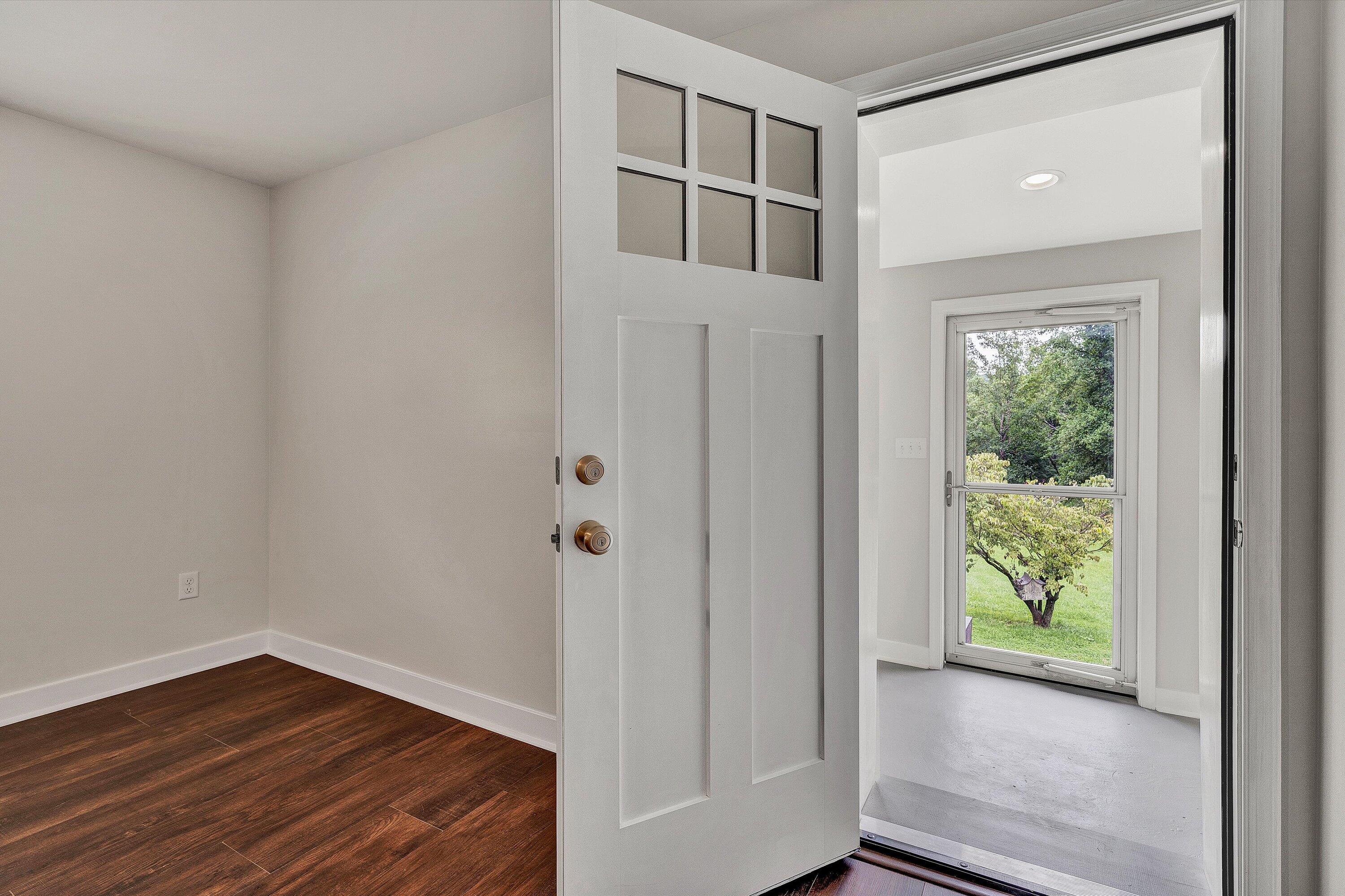 251 Meadow Branch Road Boones Mill, VA 24065 - Photo 8 of 34 a view of hallway with wooden floor and front door