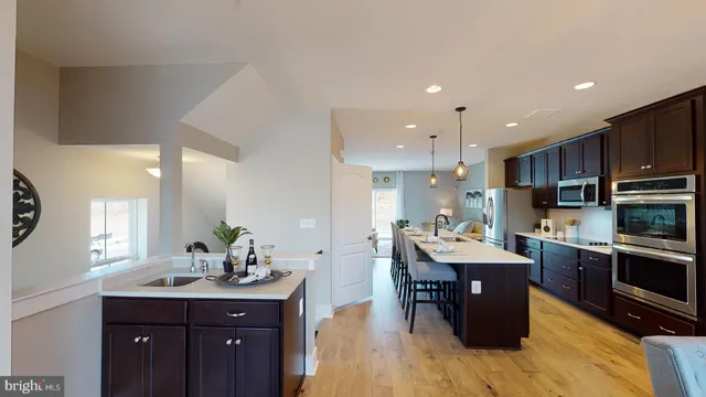 a kitchen with stainless steel appliances kitchen island granite countertop a sink and cabinets