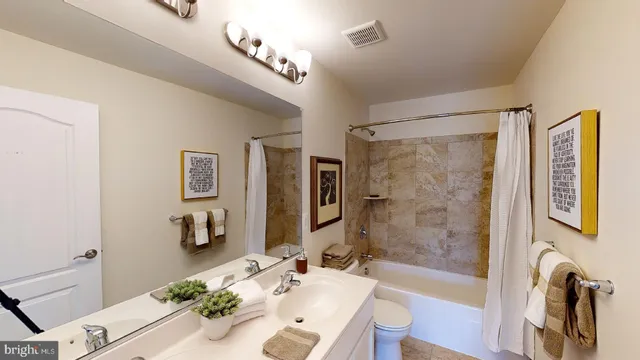 a view of walk in closet with clothes