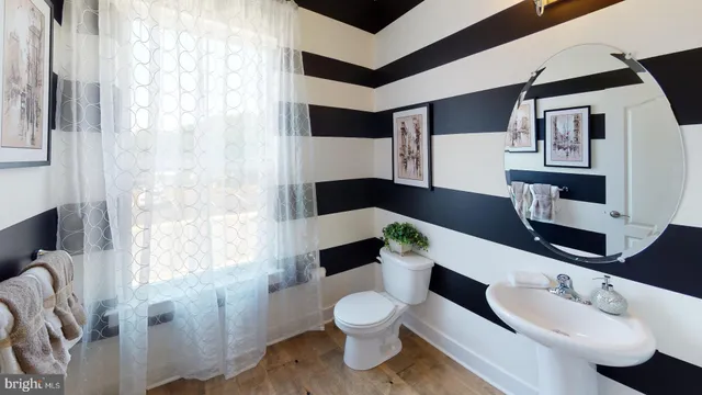 a bedroom with a bed and a mirror on dresser