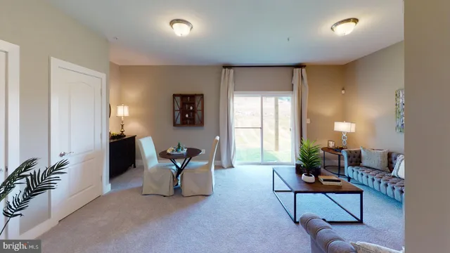 a living room with furniture and floor to ceiling window