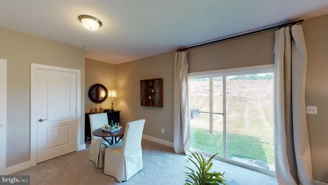 a dining room with furniture and a window