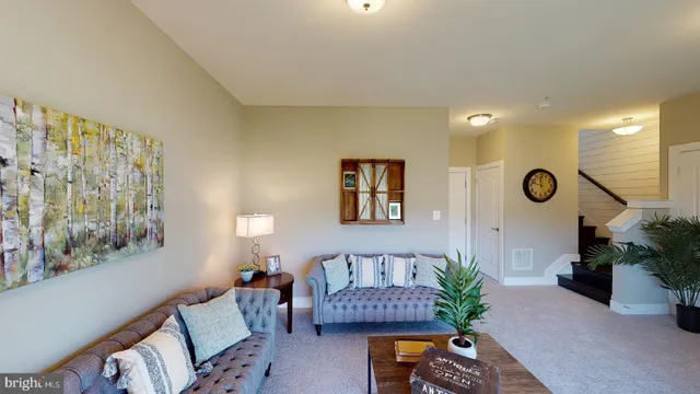 a living room with furniture and a potted plant
