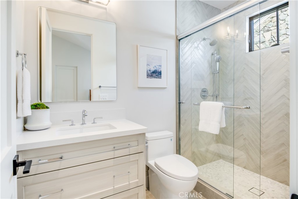 644 29th Street Manhattan Beach, CA 90266 - Photo 29 of 41 a bathroom with a granite countertop sink a toilet and a mirror