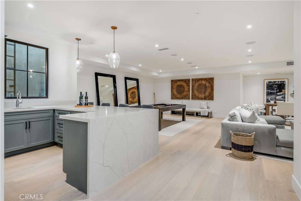 644 29th Street Manhattan Beach, CA 90266 - Photo 32 of 41 a large white kitchen with a large island in the center and a sink