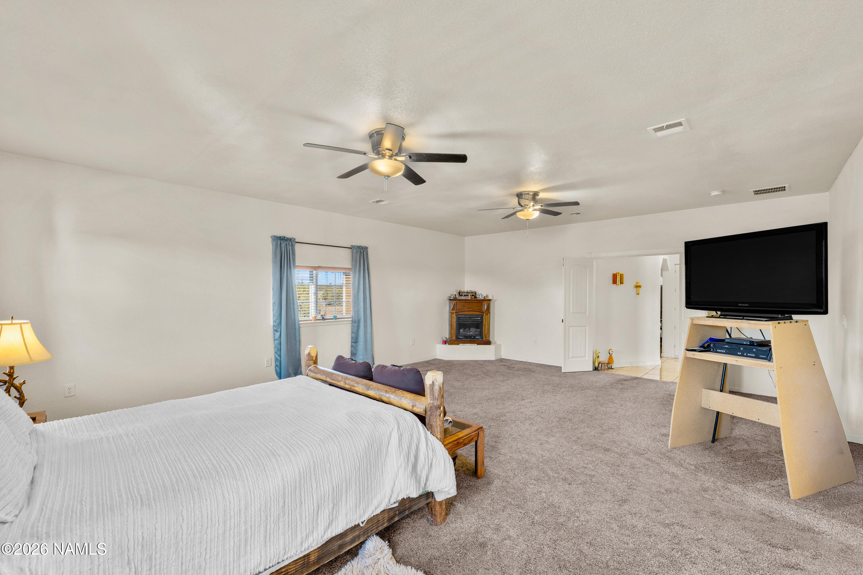 8187 Cassity Trail Williams, AZ 86046 - Photo 18 of 50 a bedroom with a bed and a flat screen tv