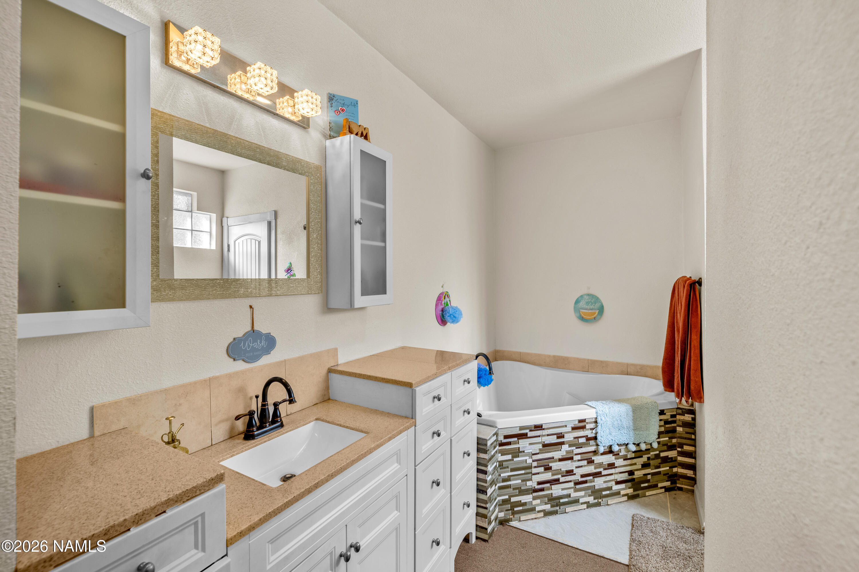 8187 Cassity Trail Williams, AZ 86046 - Photo 22 of 50 a bathroom with a sink mirror and vanity