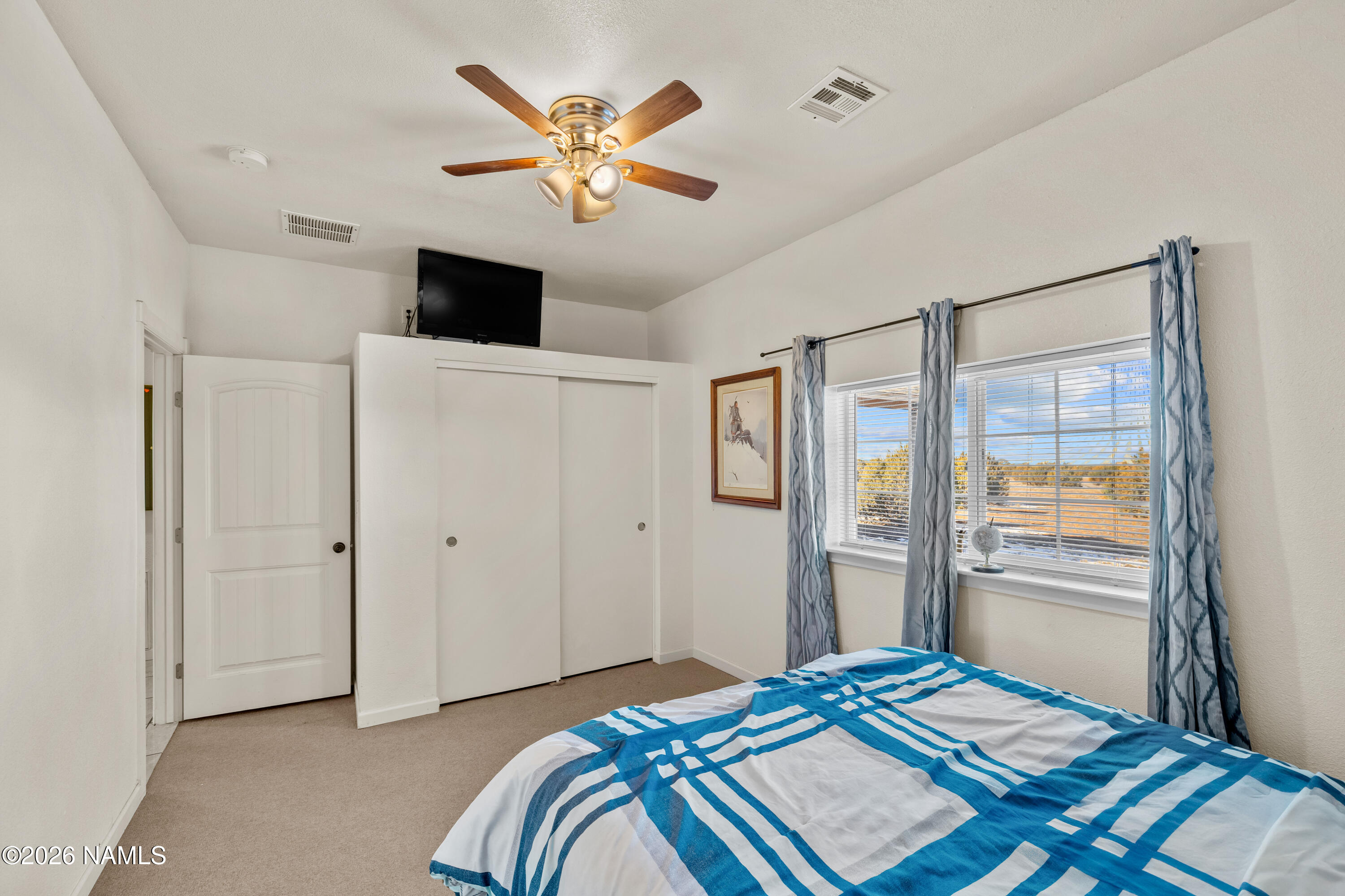 8187 Cassity Trail Williams, AZ 86046 - Photo 24 of 50 a bedroom with a bed and a chandelier