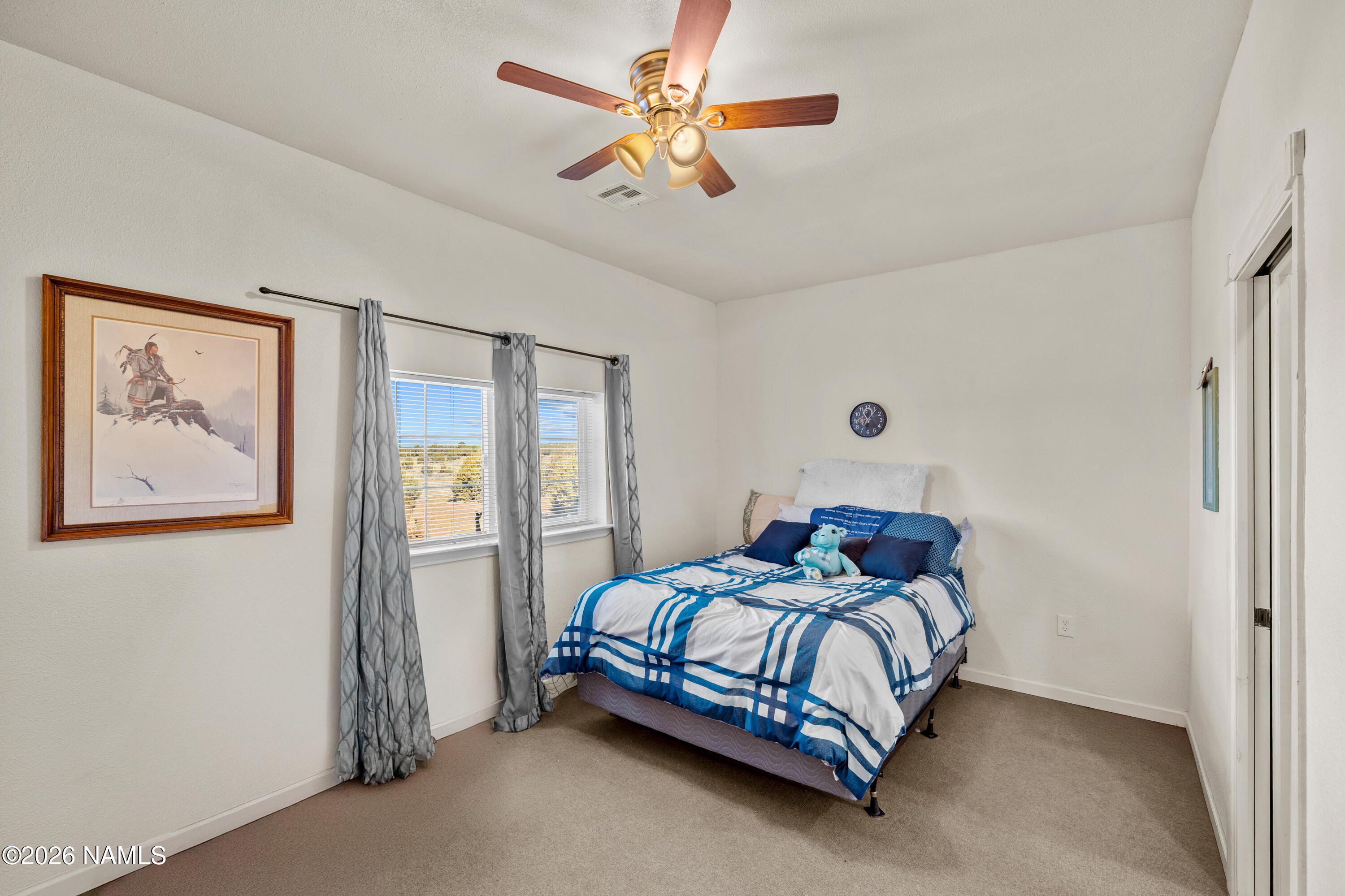8187 Cassity Trail Williams, AZ 86046 - Photo 25 of 50 a bedroom with a bed and a painting on the wall