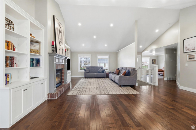 353 Robin Street Smithfield, UT 84335 - Photo 15 of 70 Living room featuring lofted ceiling, dark wood-type flooring, recessed lighting, and a fireplace