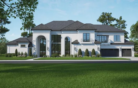 a front view of a house with a garden and yard