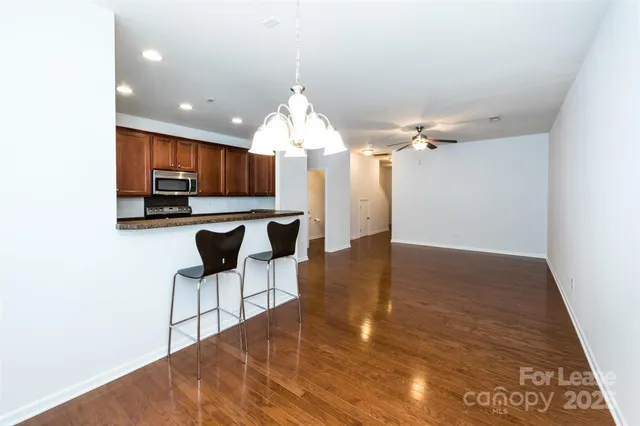 a kitchen with granite countertop wooden cabinets and stainless steel appliances