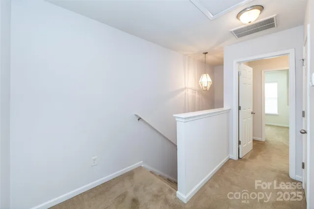 an empty room with ceiling fan and window