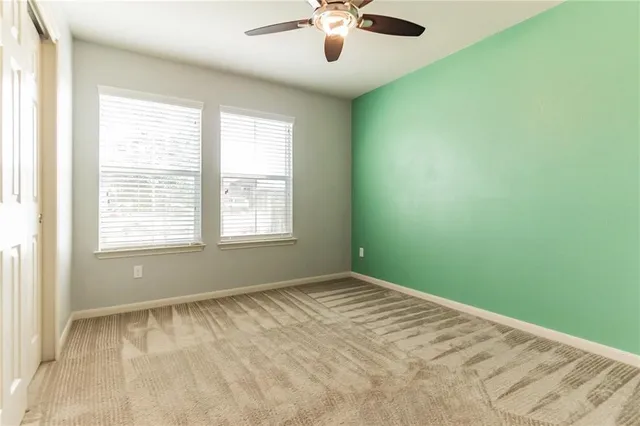 a view of room with window and ceiling fan