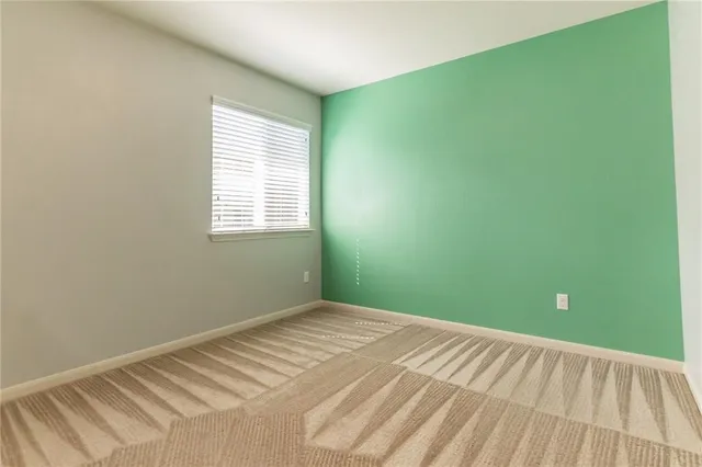 a view of a room with a fan and a window