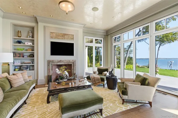 a living room with furniture fireplace and a large window