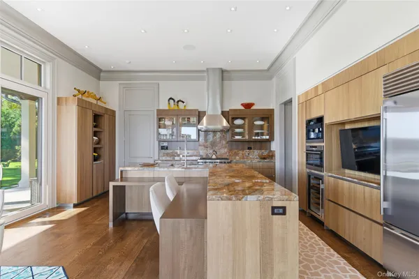 a kitchen with stainless steel appliances granite countertop a refrigerator and a stove top oven