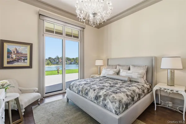 a bedroom with a large bed and a chandelier